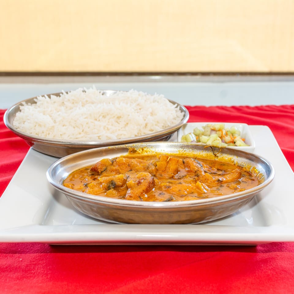 Chicken tikka masala served with rice.
